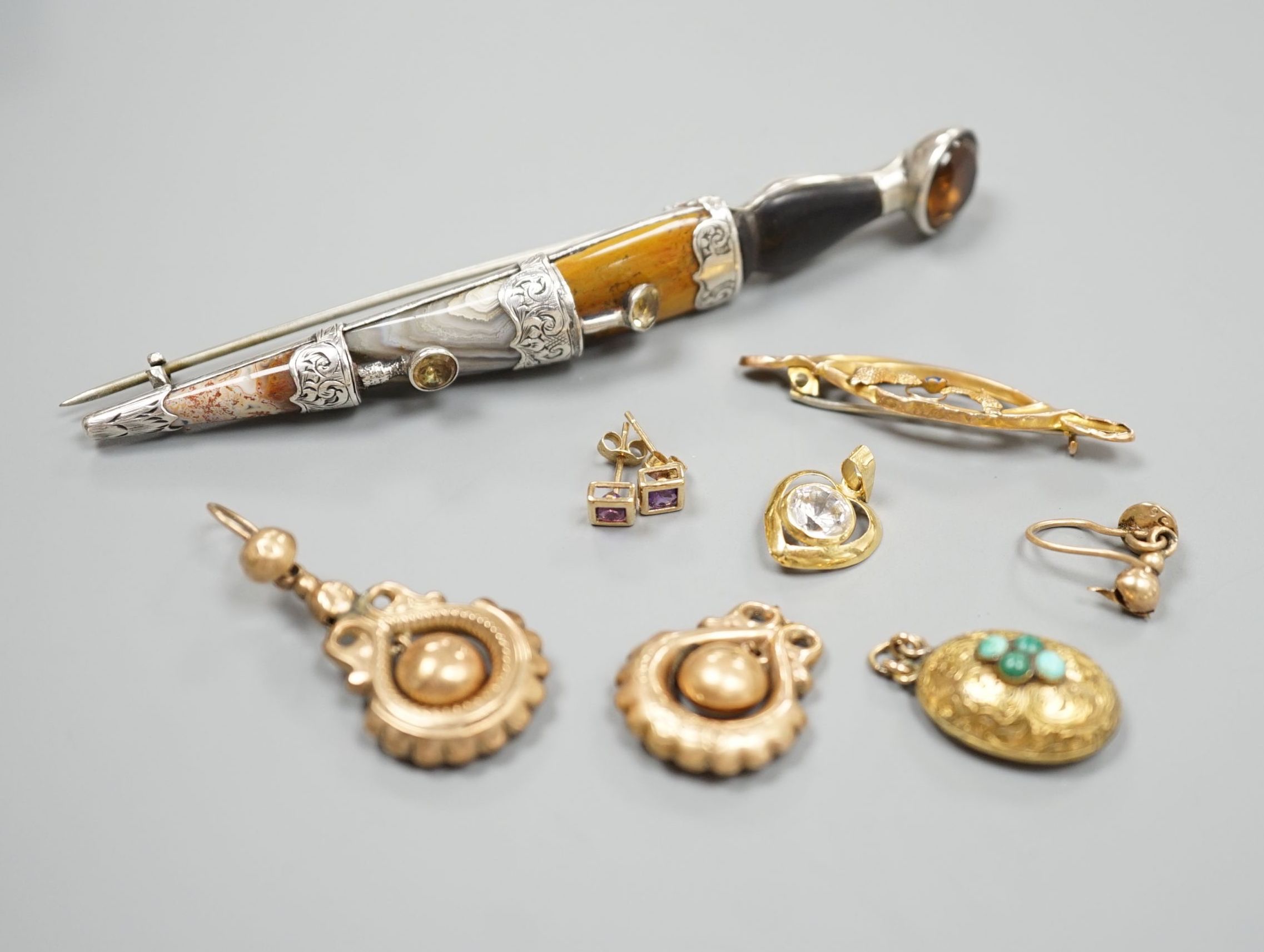 A white metal and Scottish hardstone set dirk brooch, 97mm, a pair of Victorian 9ct drop earrings, 2.1 grams, a 9ct and gem set brooch, a yellow metal and turquoise set oval pendant, a pair of modern 9ct and gen set ears